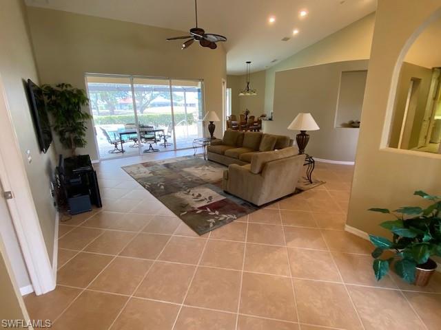 8886 Lely Island Circle Naples, FL 34113 - Photo 3 of 14 a living room with furniture and a flat screen tv