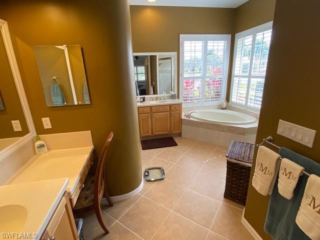 8886 Lely Island Circle Naples, FL 34113 - Photo 6 of 14 a bathroom with a tub sink and mirror