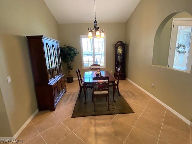 8886 Lely Island Circle Naples, FL 34113 - Photo 7 of 14 a living room with furniture a window and a chandelier