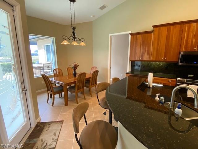 8886 Lely Island Circle Naples, FL 34113 - Photo 8 of 14 a view of a dining room with furniture window and outside view