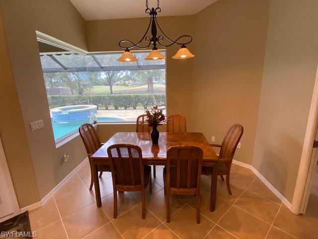 8886 Lely Island Circle Naples, FL 34113 - Photo 10 of 14 a view of a dining room with furniture and window