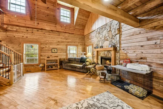 a spacious bedroom with a bed and wooden floor