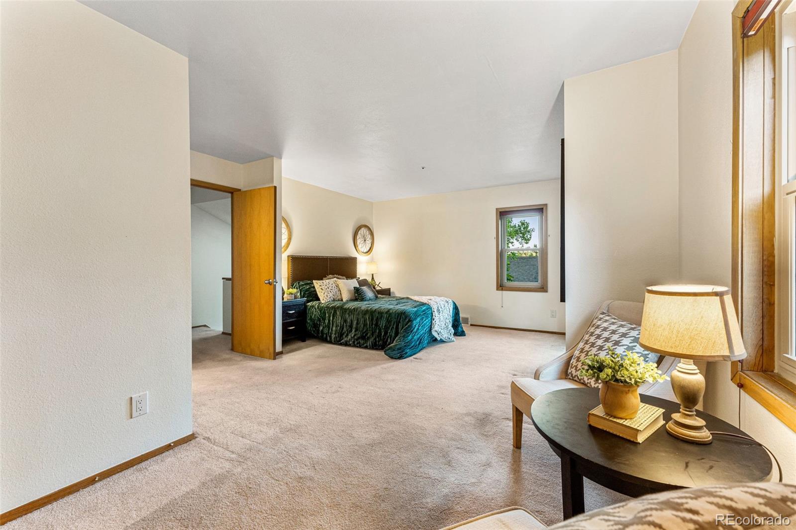 1343 Alpine Avenue Boulder, CO 80304 - Photo 24 of 39 a bedroom with furniture and a lamp