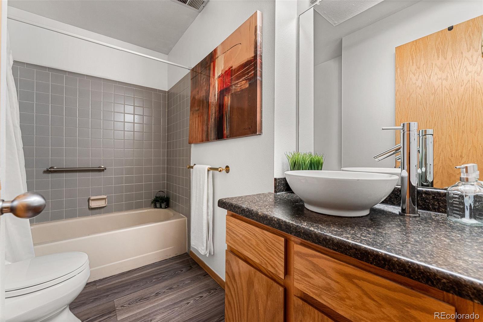 1343 Alpine Avenue Boulder, CO 80304 - Photo 30 of 39 a bathroom with a granite countertop tub a sink and a large mirror
