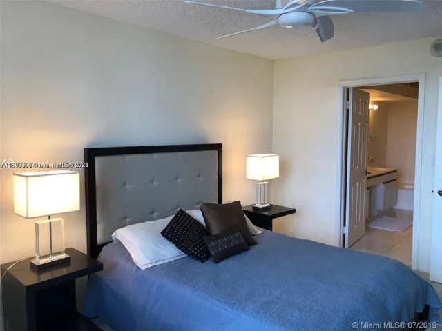 a bedroom with a bed and a lamp