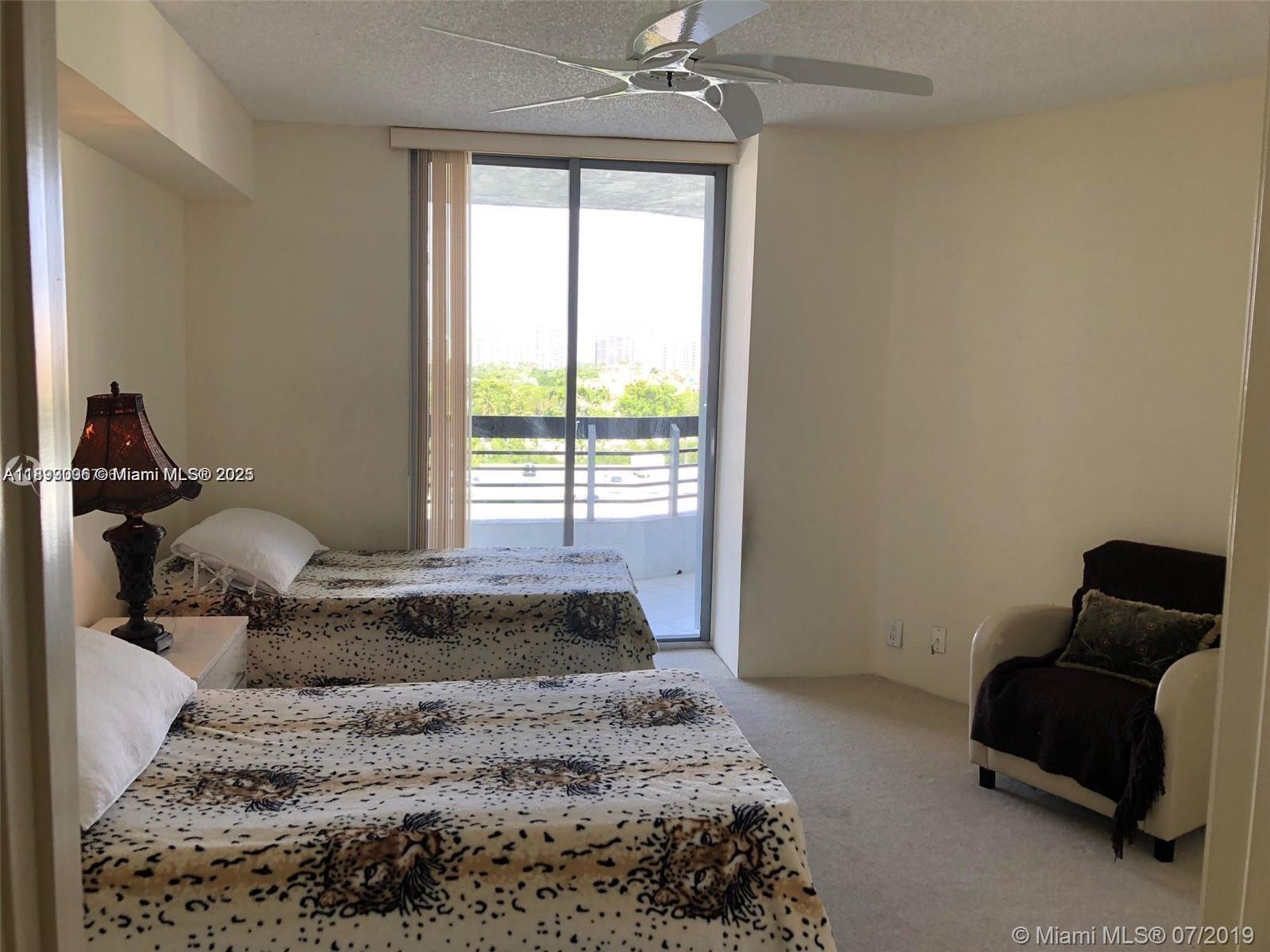3530 Mystic Pointe Drive, Unit 1008 Aventura, FL 33180 - Photo 16 of 32 a bedroom with a bed and window