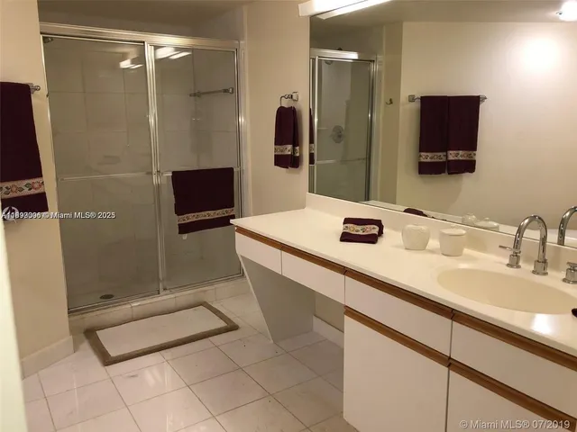 a bathroom with a sink a double vanity and a mirror