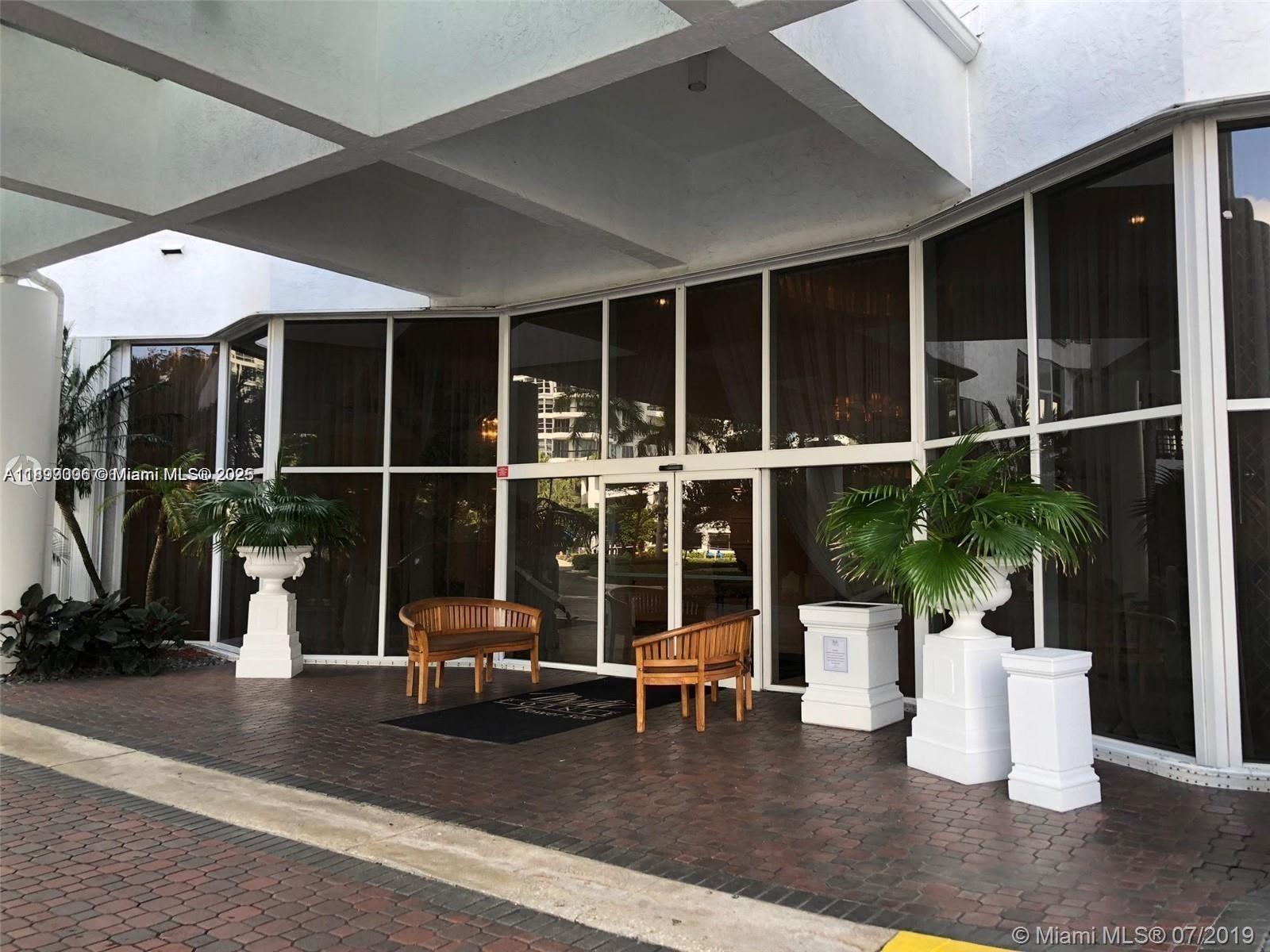 3530 Mystic Pointe Drive, Unit 1008 Aventura, FL 33180 - Photo 20 of 32 a living room with furniture potted plant and a large window