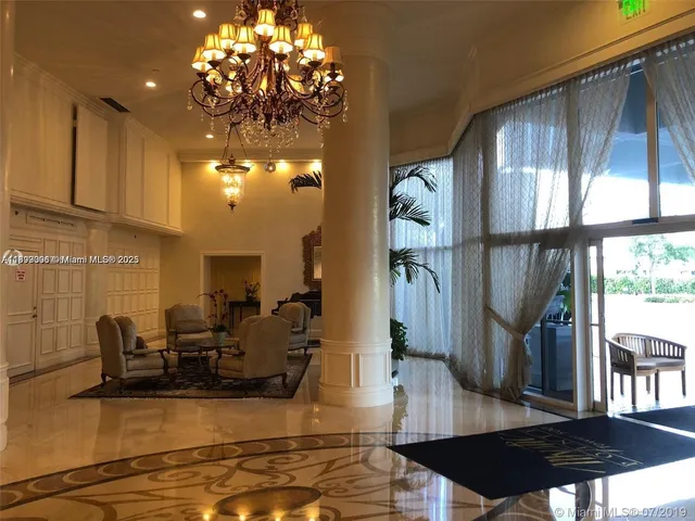 a view of a living room with furniture and a chandelier