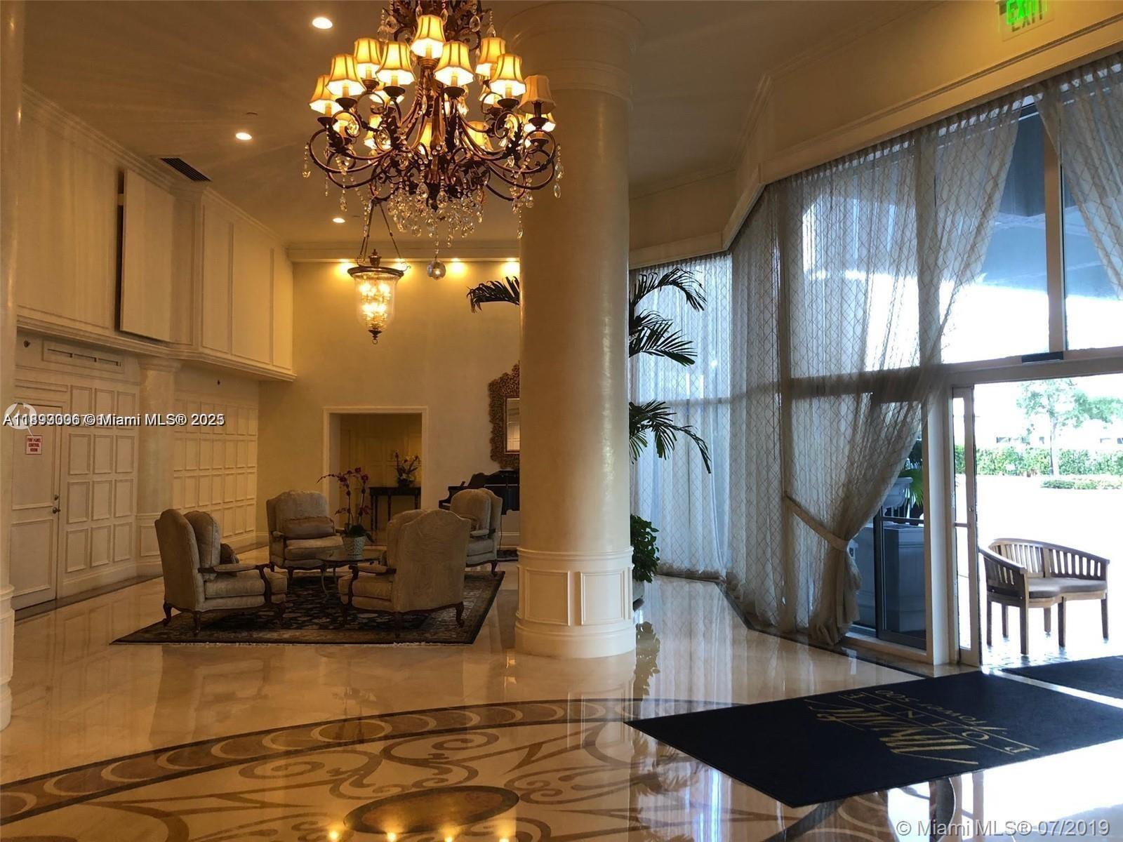 3530 Mystic Pointe Drive, Unit 1008 Aventura, FL 33180 - Photo 21 of 32 a view of a living room with furniture and a chandelier