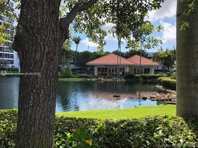 a backyard of a house with lots of green space and lake view
