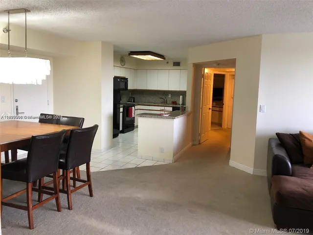 a kitchen with a table and chairs in it