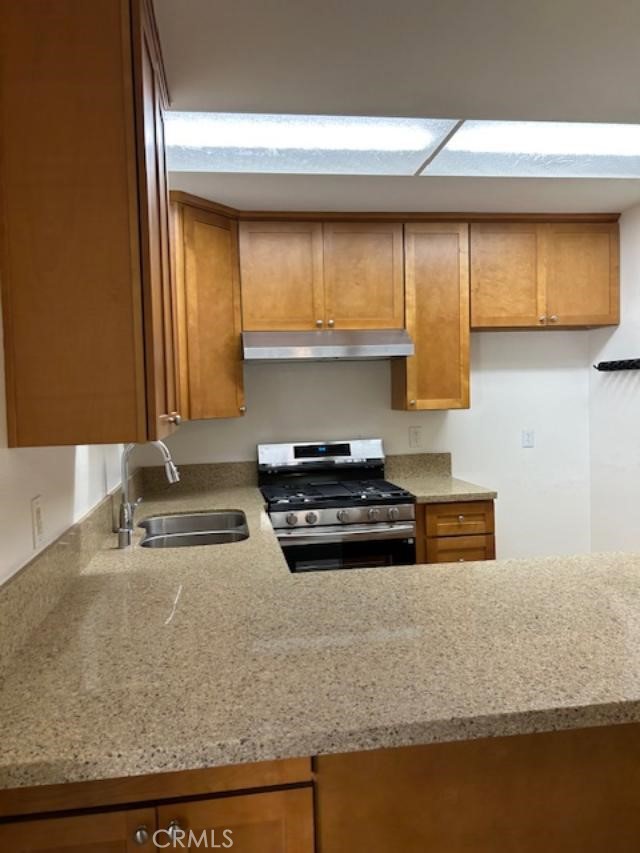 16642 Goldenwest Street Huntington Beach, CA 92647 - Photo 11 of 27 a kitchen with stainless steel appliances granite countertop a sink and a stove