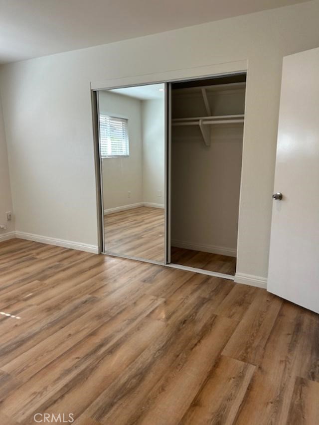 16642 Goldenwest Street Huntington Beach, CA 92647 - Photo 15 of 27 an empty room with wooden floor closet and windows