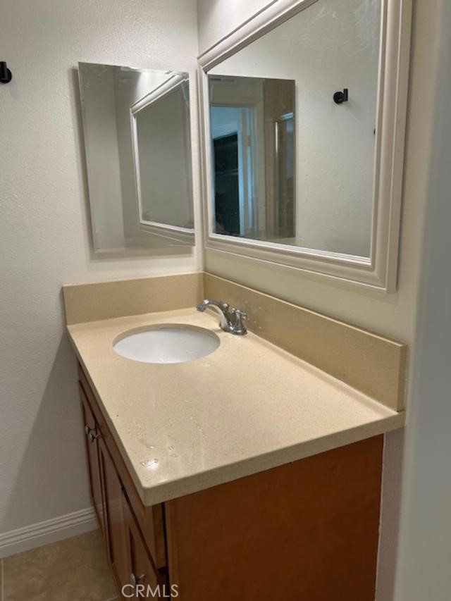 16642 Goldenwest Street Huntington Beach, CA 92647 - Photo 18 of 27 a bathroom with a sink and a mirror