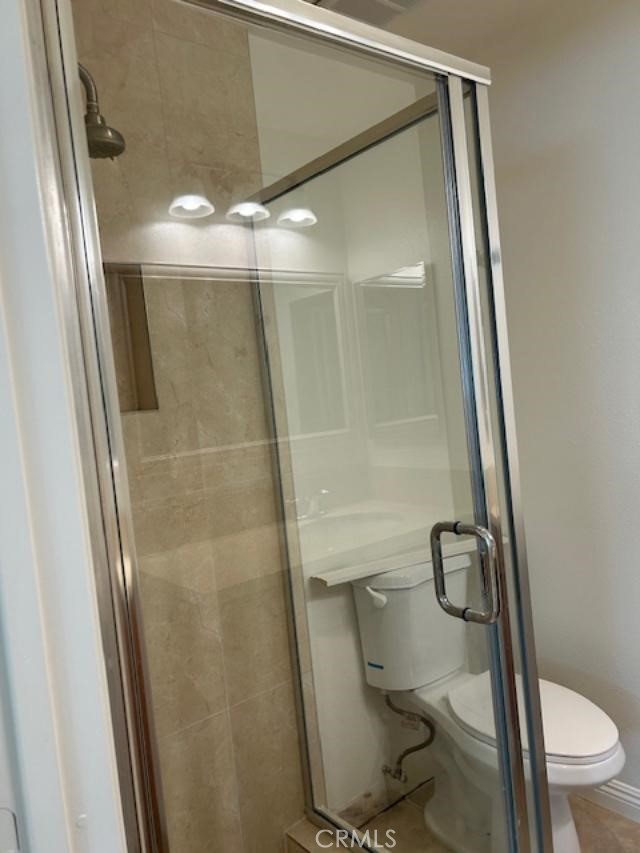 16642 Goldenwest Street Huntington Beach, CA 92647 - Photo 19 of 27 a bathroom with a granite countertop toilet and a shower