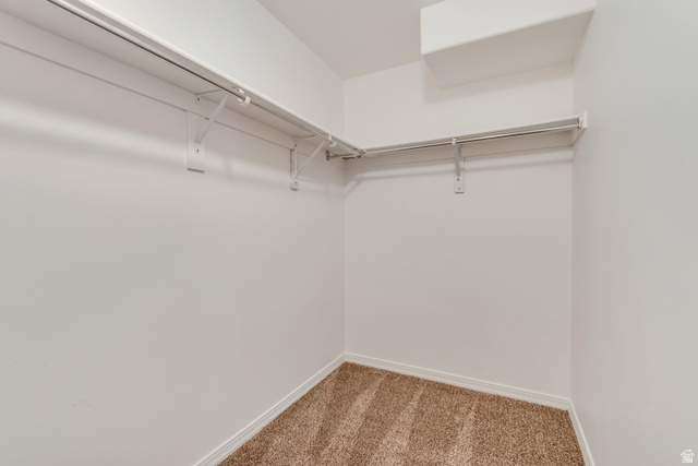 546 Wheatridge Road Tooele, UT 84074 - Photo 33 of 49 3rd Bedroom walk-in closet featuring light brown carpeting, white walls, and built-in white wire shelving with hanging rods