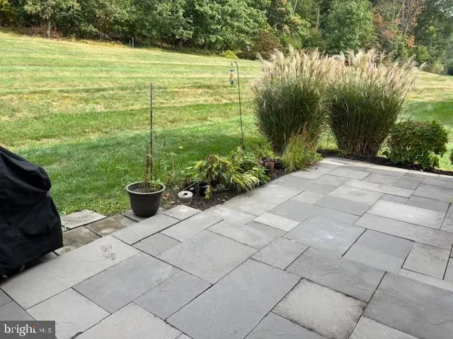 a vase of flowers sitting on a floor