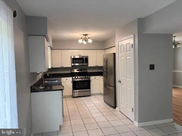a kitchen with stainless steel appliances a refrigerator and a stove