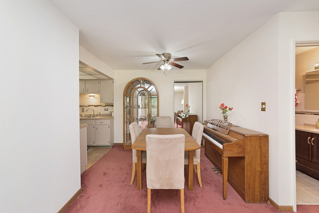 903 Elder Road, Unit 8 Homewood, IL 60430 - Photo 3 of 13 a view of a livingroom with furniture a ceiling fan and wooden floor
