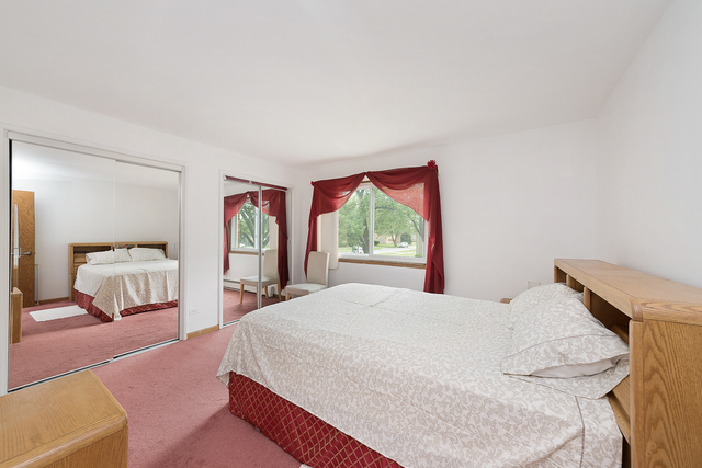 903 Elder Road, Unit 8 Homewood, IL 60430 - Photo 8 of 13 a bedroom with a large bed and a large window