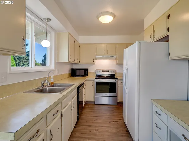 a kitchen with a sink a stove and refrigerator