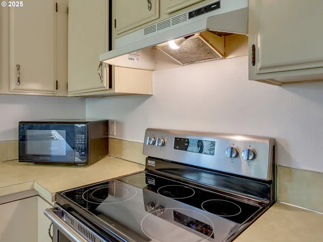 a stove top oven sitting inside of a kitchen