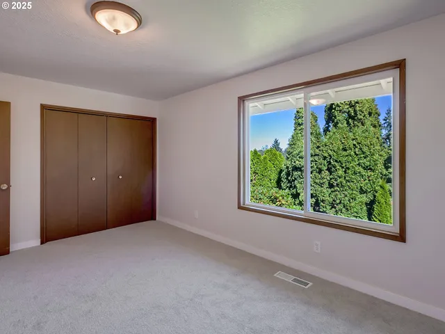 an empty room with windows and view