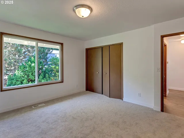 an empty room with windows and view