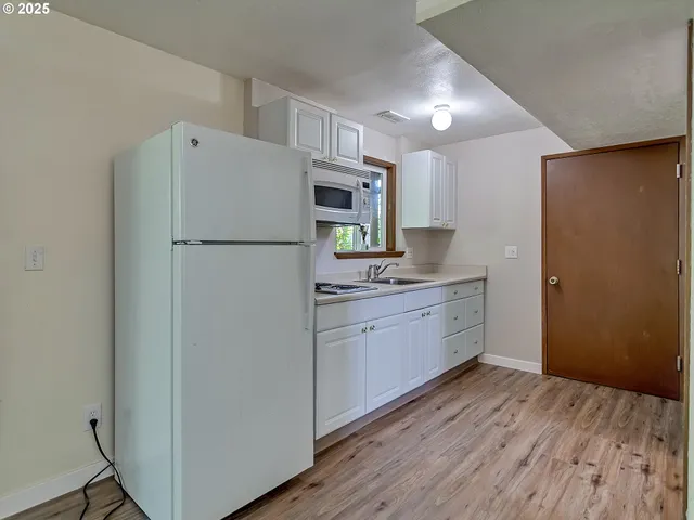 a kitchen with a refrigerator sink and microwave