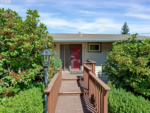 a view of a house with brick walls and flower plants