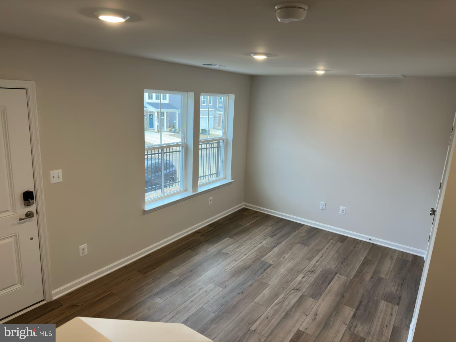 1256 Red Clover Lane, Unit 149 Ranson, WV 25438 - Photo 6 of 17 a view of an empty room with wooden floor and a window
