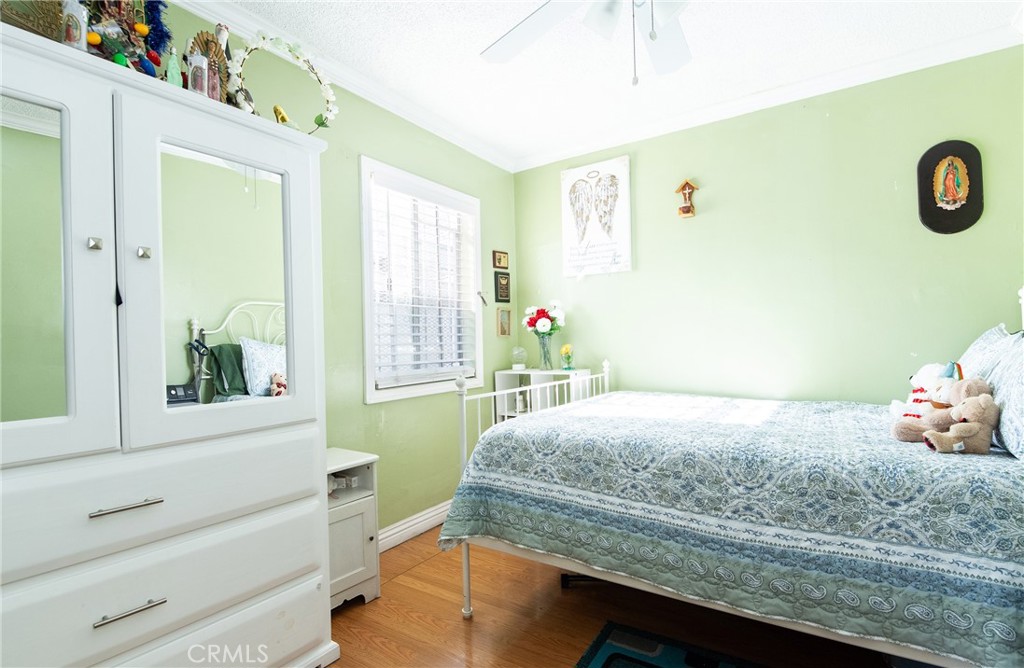 2121 East Shauer Street Compton, CA 90222 - Photo 20 of 30 a bedroom with a bed and a window