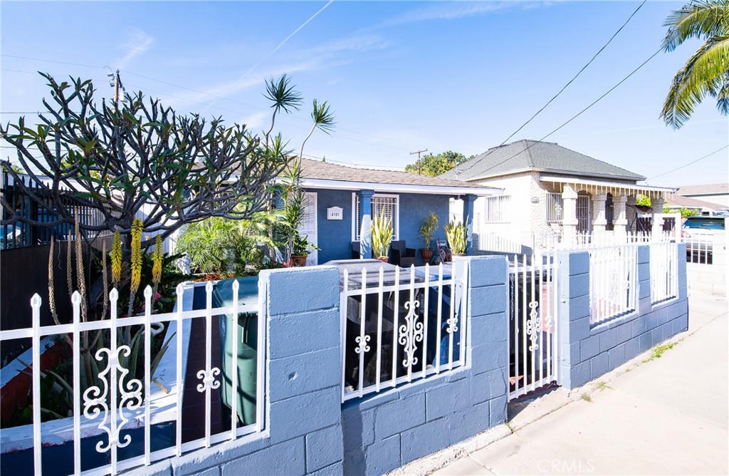 2121 East Shauer Street Compton, CA 90222 - Photo 2 of 30 a view of a house with wooden fence