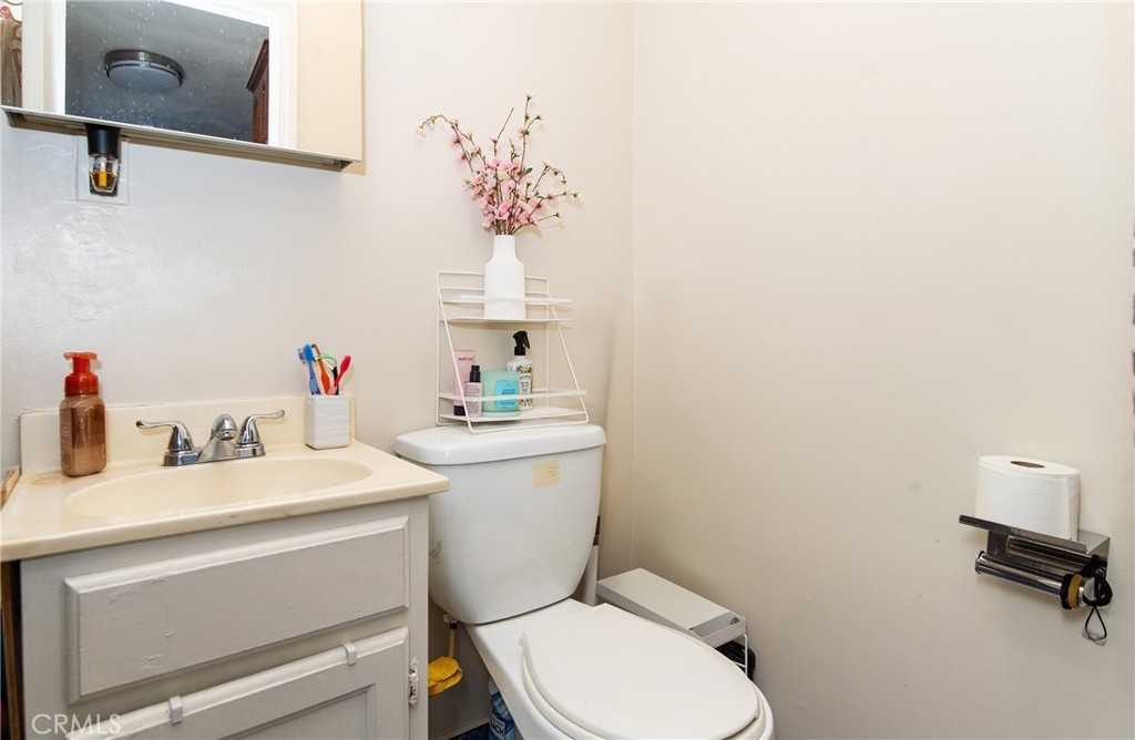 2121 East Shauer Street Compton, CA 90222 - Photo 29 of 30 a bathroom with a sink vanity mirror and toilet