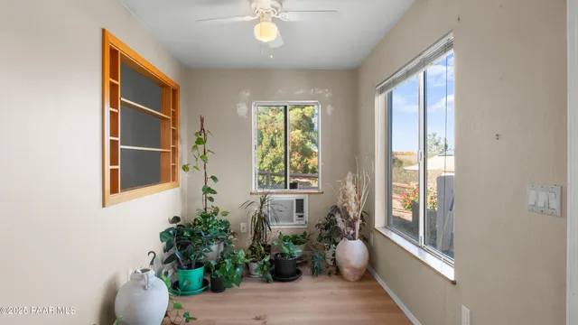 a view of a patio with table and chairs and potted plants