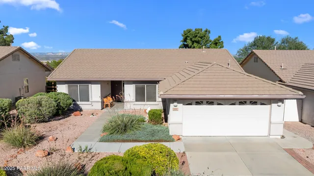 aerial view of a house with a yard and potted plants