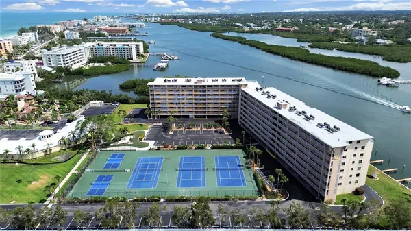 a view of a city with lots of residential buildings ocean and mountain view
