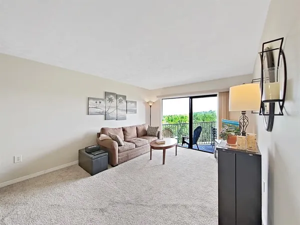 a living room with furniture large window and flat screen tv