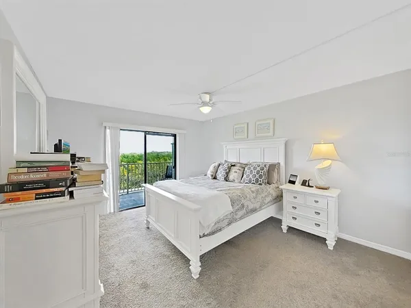 a bedroom with a bed and a large window