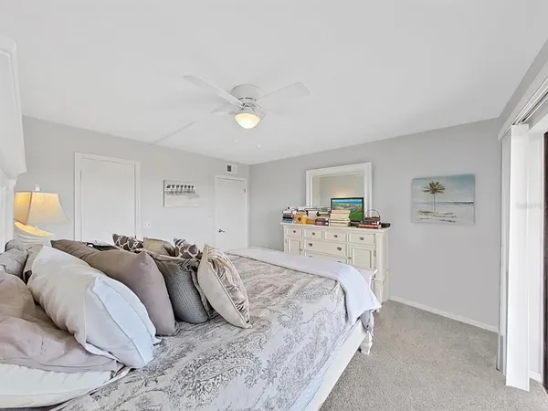 a bedroom with a bed and a lamp