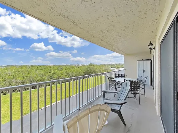 a view of a balcony with chairs