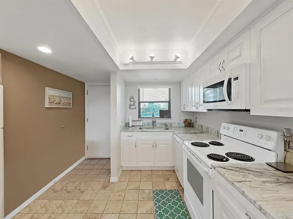 a kitchen with a stove a sink and a microwave