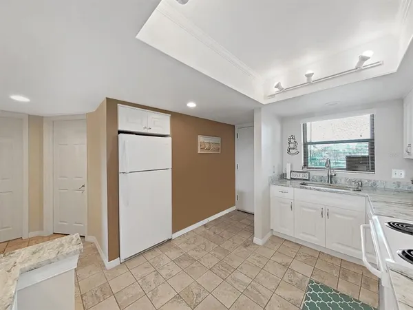a large bathroom with a granite countertop sink and a mirror