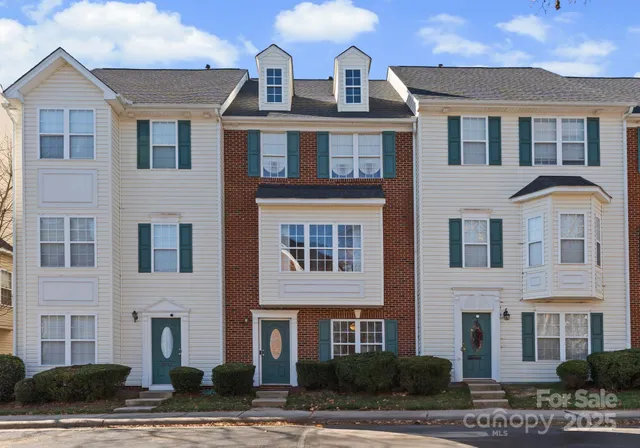 a front view of a building with a yard
