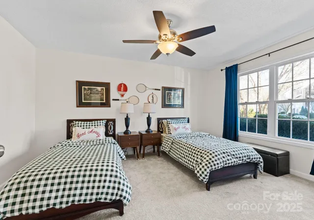 a bedroom with a bed couch and window