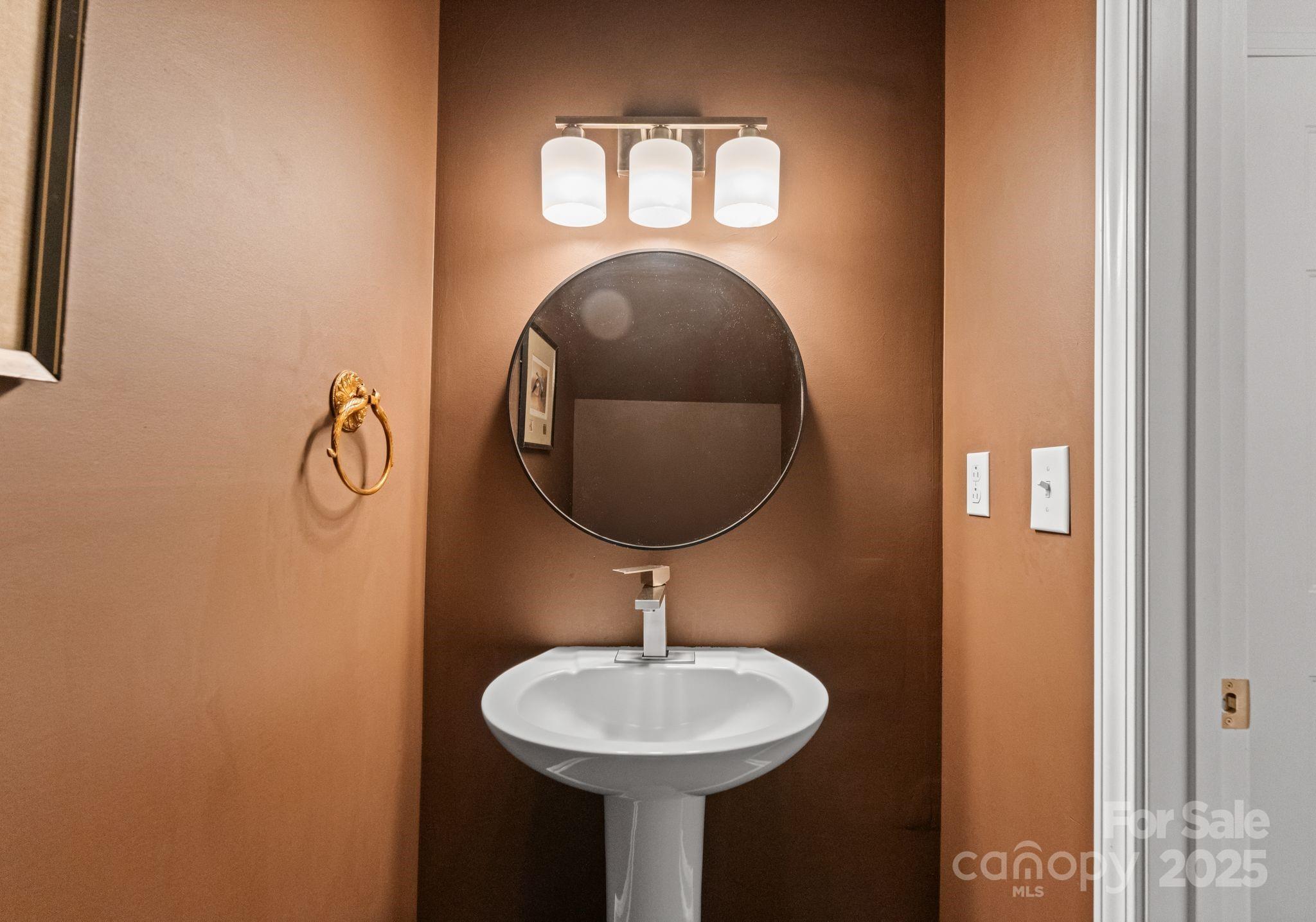 9930 Treeside Lane Matthews, NC 28105 - Photo 16 of 20 a bathroom with a toilet sink and mirror