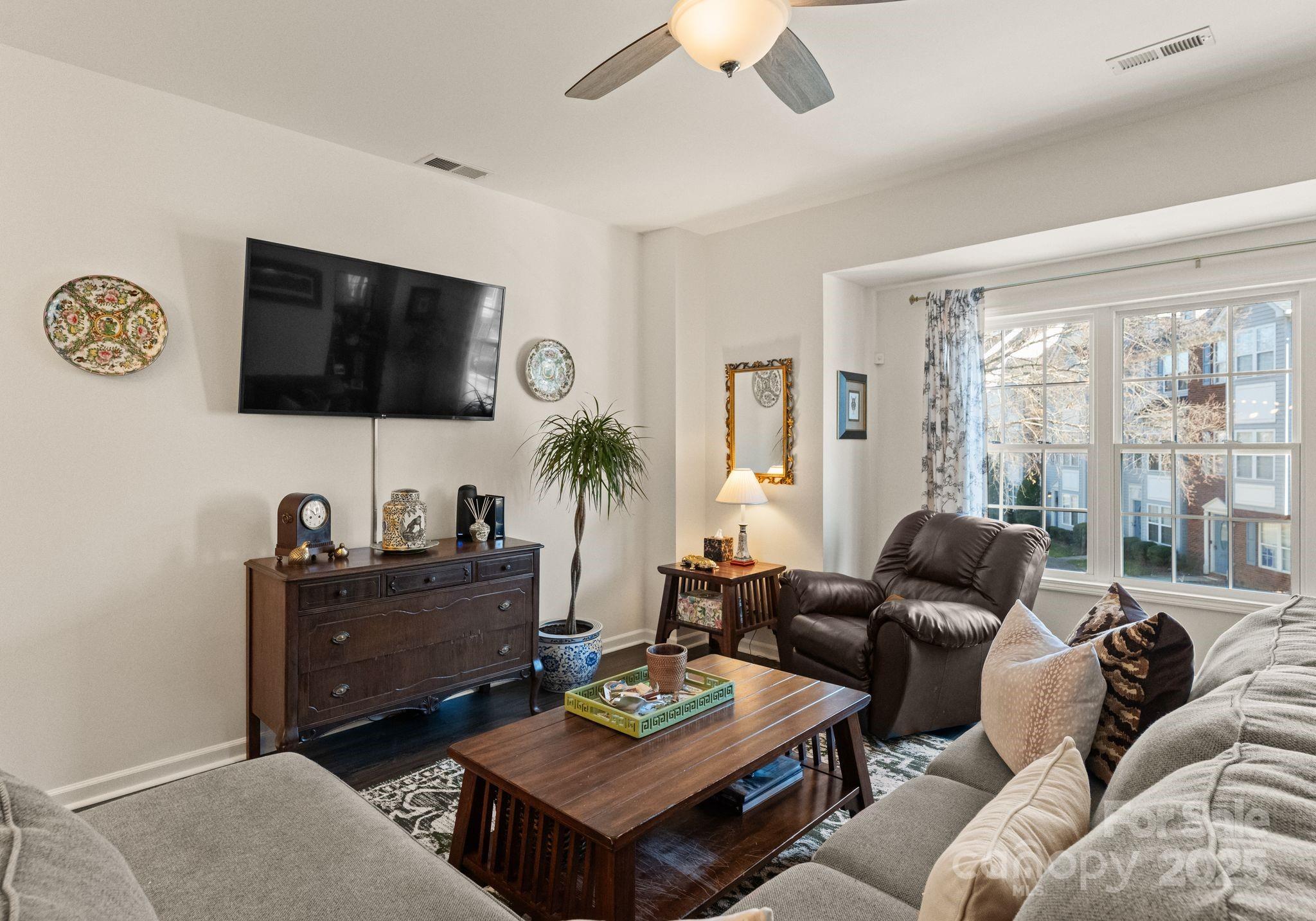 9930 Treeside Lane Matthews, NC 28105 - Photo 4 of 20 a living room with furniture a flat screen tv and a window