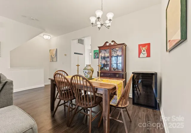 a view of a dining room with furniture and chandelier