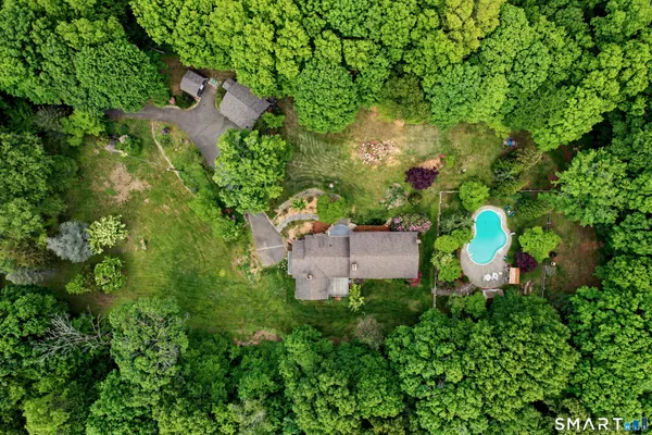 an aerial view of a house with a yard and lake view